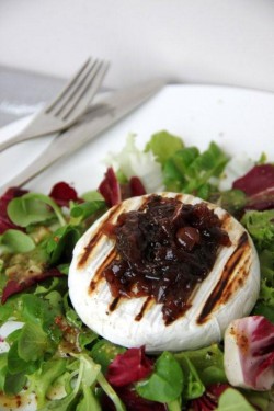 Grilled Camembert served on the bed of salad with vinaigrette sauce and onion preserves / Grillo ...